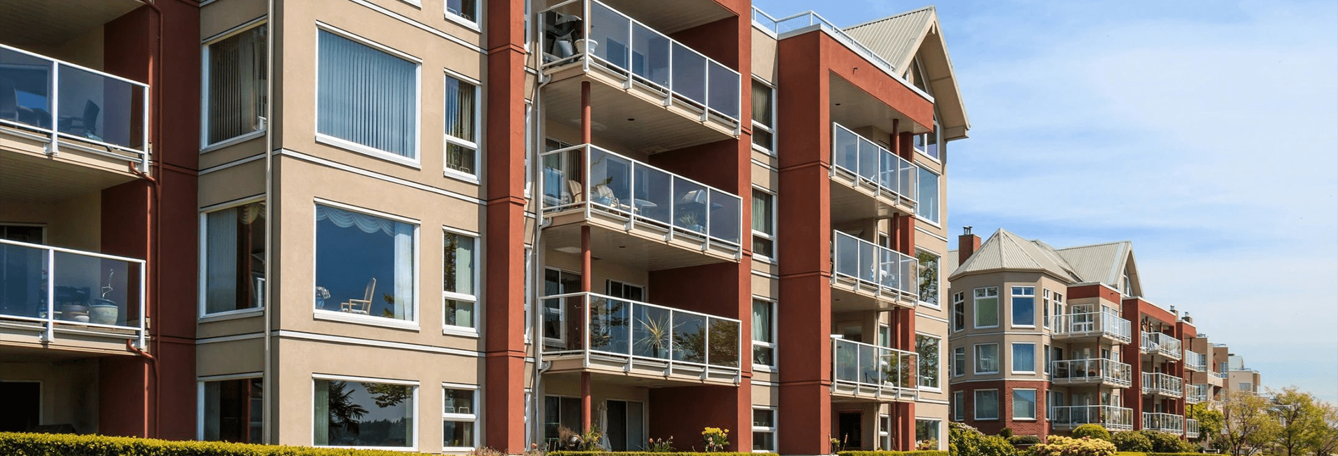 A building with balconies and glass railings.