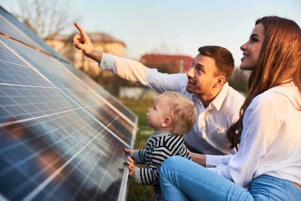 A family is looking at the solar panel.