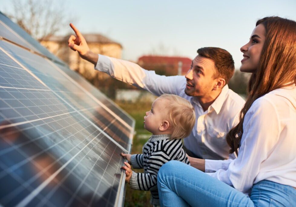A family is looking at the solar panel.